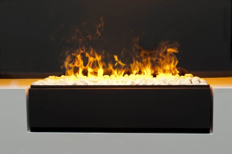 Insert électrique à poser Cassette L Galets de Dimplex vu de face avec sa flamme orangée au centre